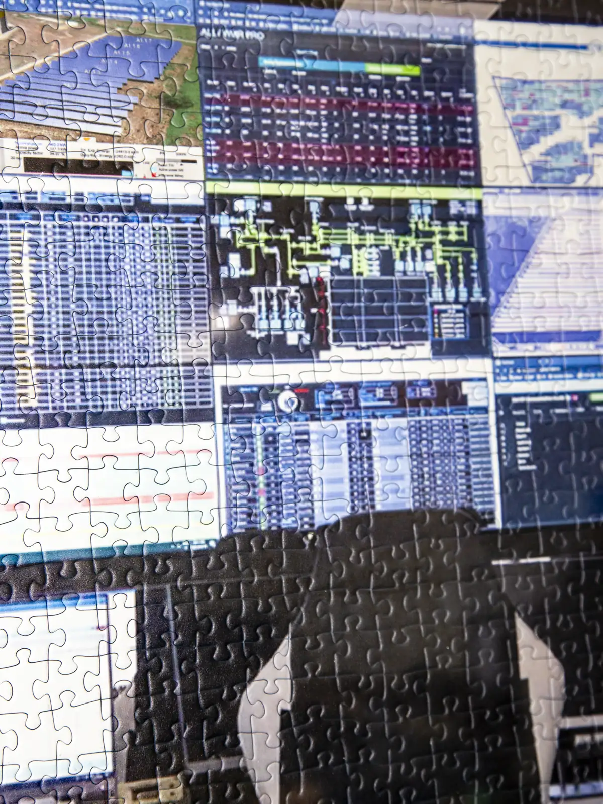 Control-room screens with a jigsaw-puzzle overlay